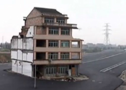 中国・高速道路の真ん中に取り残された住居